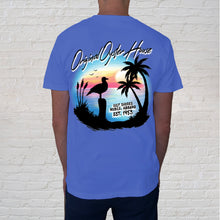 Load image into Gallery viewer, Airbrush Palms Flo Blue back of tee: T-shirt design is a nod to the golden days of airbrush artists who stunned tourists with their abilities of capturing a memorable scene as a keepsake of their stay.&nbsp;Featuring a vignette of palms, sea oats and a perched seagull overlooking the beaches of&nbsp;Gulf Shores, this collectible tee captures the authentic charm of a hand-airbrushed original.
