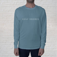 Load image into Gallery viewer, Front: A year-round attraction, Gulf Shores features sugar-white sand beaches, turquoise waters, and stunning sunsets. The Gulf Shores front imprint on a Ice Blue Comfort Color long sleeve t-shirt is one of our best selling tees.
