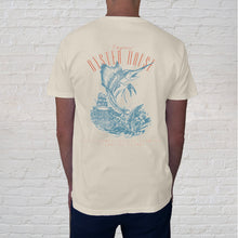 Load image into Gallery viewer,  The Overboard Tee ivory back design, features a leaping sailfish, a perfect memento for anglers and Gulf Shores visitors. 
