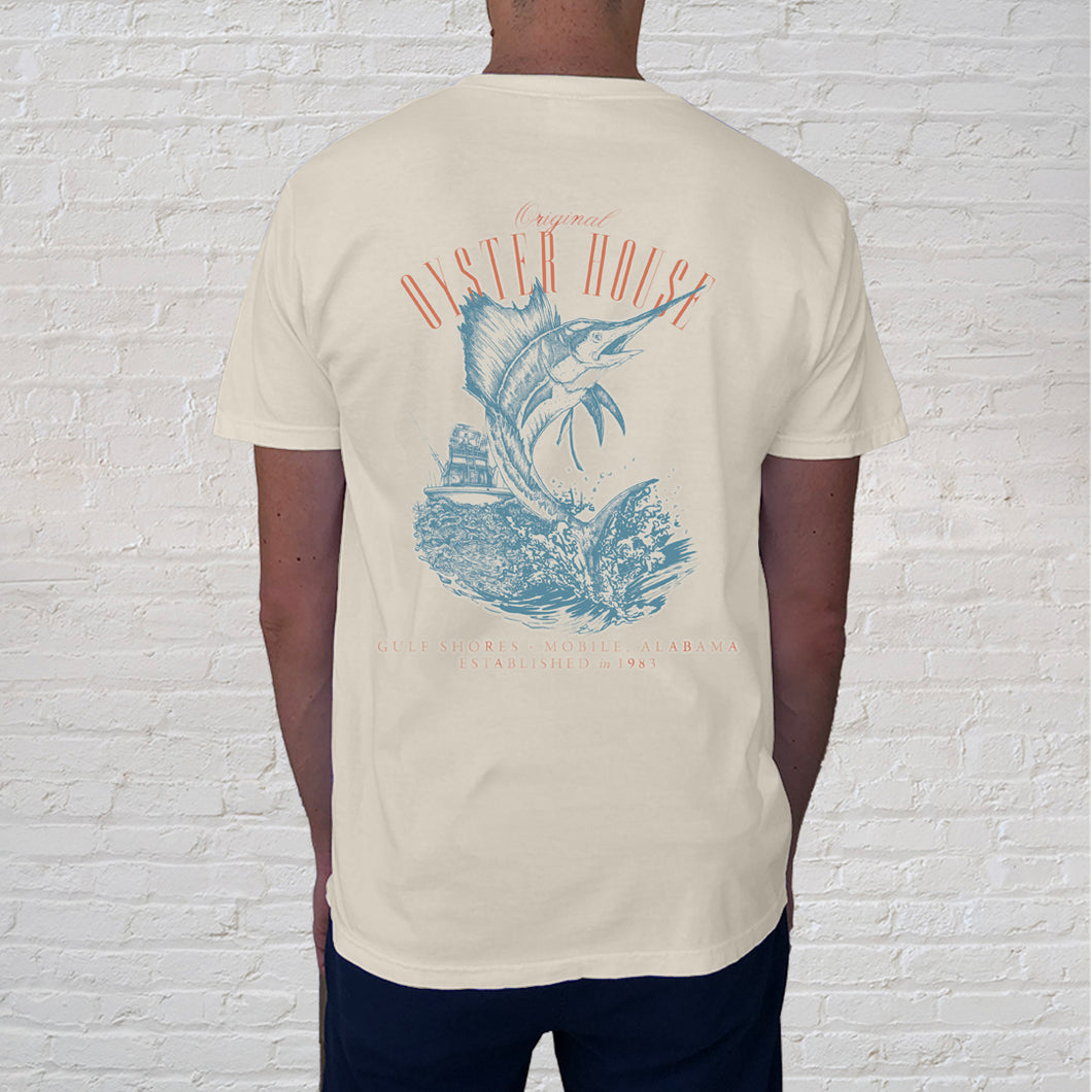  The Overboard Tee ivory back design, features a leaping sailfish, a perfect memento for anglers and Gulf Shores visitors. 