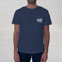Load image into Gallery viewer, Front of Tee: Sunset Oyster Boat Blue has the Original Oyster House logo on the front pocket.
