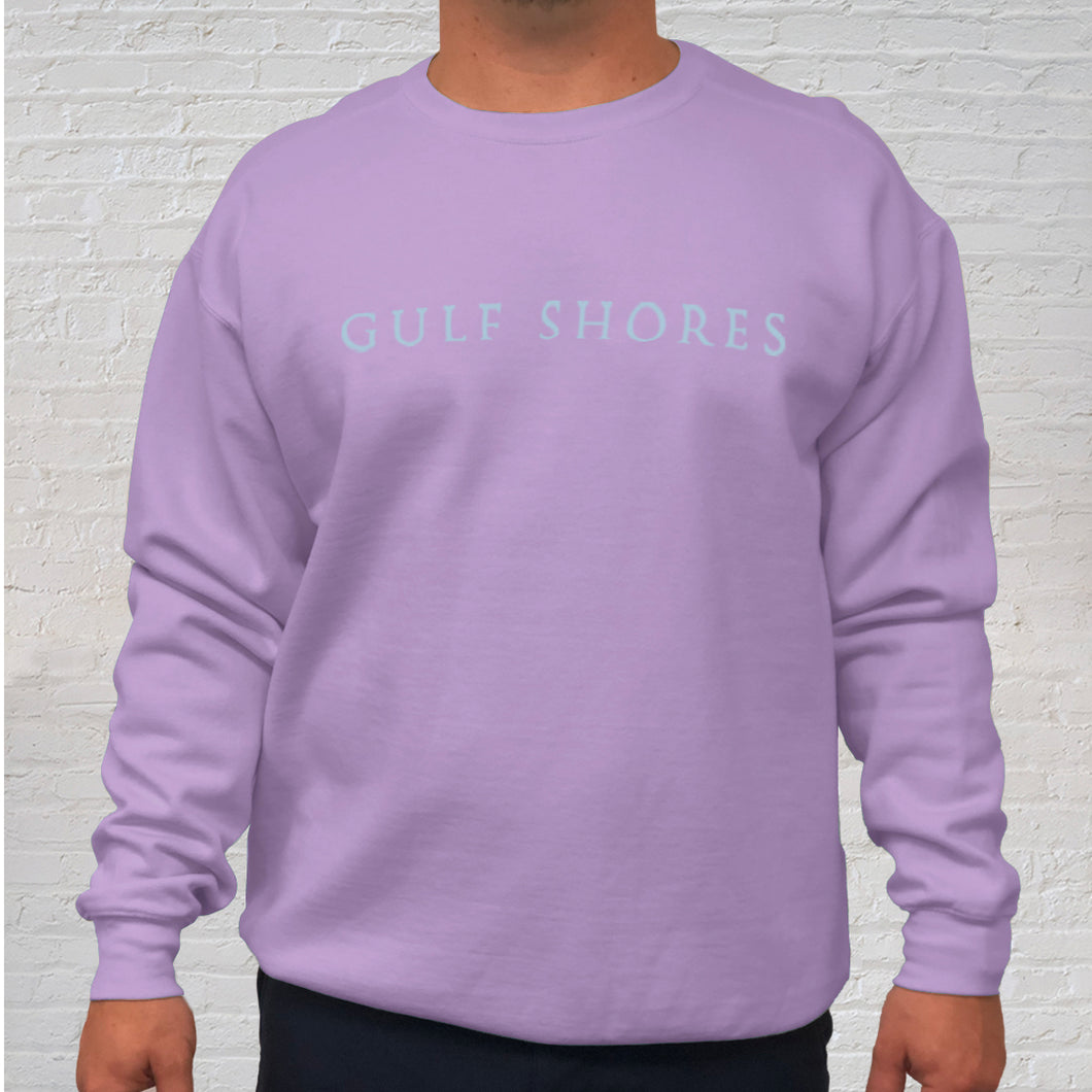 The Orchid Comfort Color crewneck sweatshirt is made of 100% ring-spun cotton. Gulf Shores is imprinted in magenta on the front. This popular beach destination has a warm, humid climate tempered by sea breezes during the summer months and near-perfect 70 degrees in November. Front view.