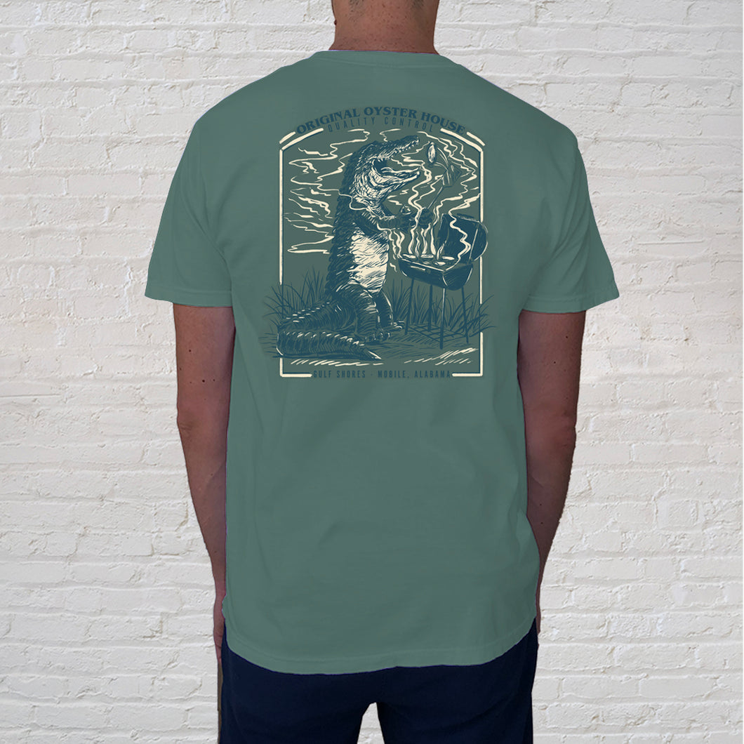 Back of t-shirt design | Down in these parts, seeing an alligator isn’t that rare, but spotting one grilling, is another story. The American alligator resides nearly exclusively in the freshwater rivers, lakes, swamps, and marshes of Southeastern United States. 