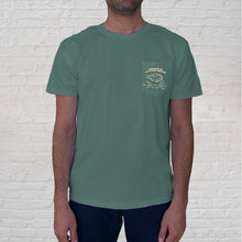 Load image into Gallery viewer, Front of t-shirt design | Tourists and locals alike are fascinated by this once endangered coastal reptile. So next time you’re in our neck of the woods, try and spot a gator or stop in for crowd-pleasing deep-fried gator bites dipped in sweet and spicy gator sauce. This Gator Grilling Green tshirt is the perfect takeaway for your special grill master or any gator fan! This limited-edition, collectible t-shirt features the front pocket design branded with the Original Oyster House logo.
